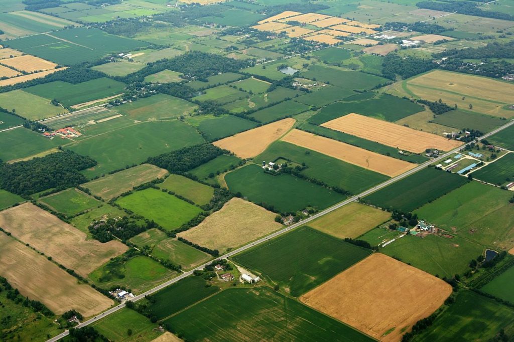 An aerial photograph of farmlands. Farming and land use has often been linked to environmental destruction.