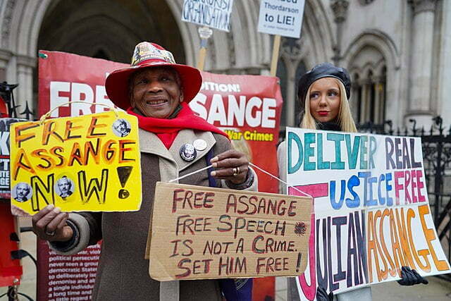Protesters demand the release of Julian Assange. 